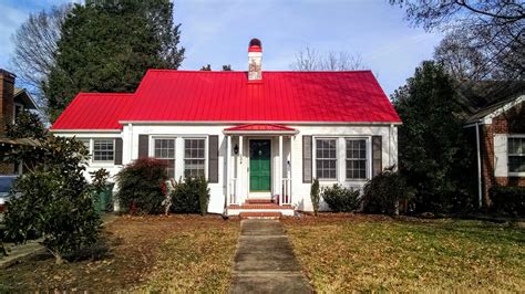 white brick house with red metal roof|brick homes with metal roofs.